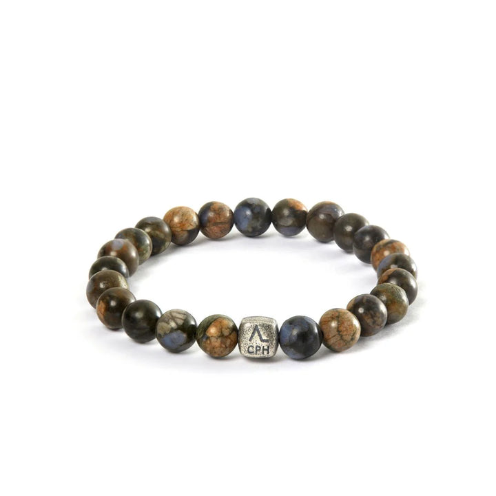 Alexander Lynggaard Armband Glaucophane 8mm visar ett armband av runda, bruna och blå stenar med en metallpärla, modell c01180-001