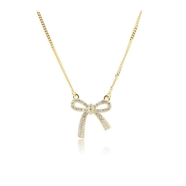 Aqua Dulce Elegant Bow Necklace Guldpläterat med rosetthänge i guldlook och gnistrande stenar, modell 5817-1.