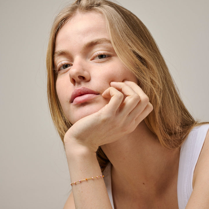 Enamel Lola Armband Blush i guldpläterat silver dyker upp på handleden, fina pastellfärgade pärlor, modell b66g-blush-2