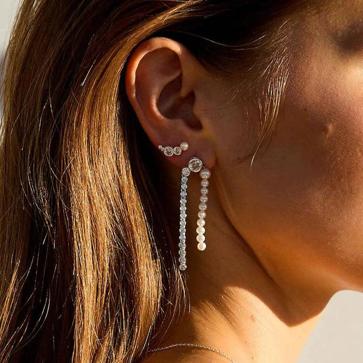 Hultquist Copenhagen Harper Croissant silverörhänge som visas på örat med blank finish i solljus. Modell S08607S-2