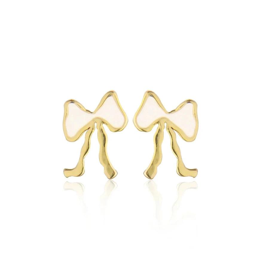 Jeberg Petite Bow White Stud Bow Earrings visar ett par små guld- och vitfärgade rosettörhängen. Modell 52815-1