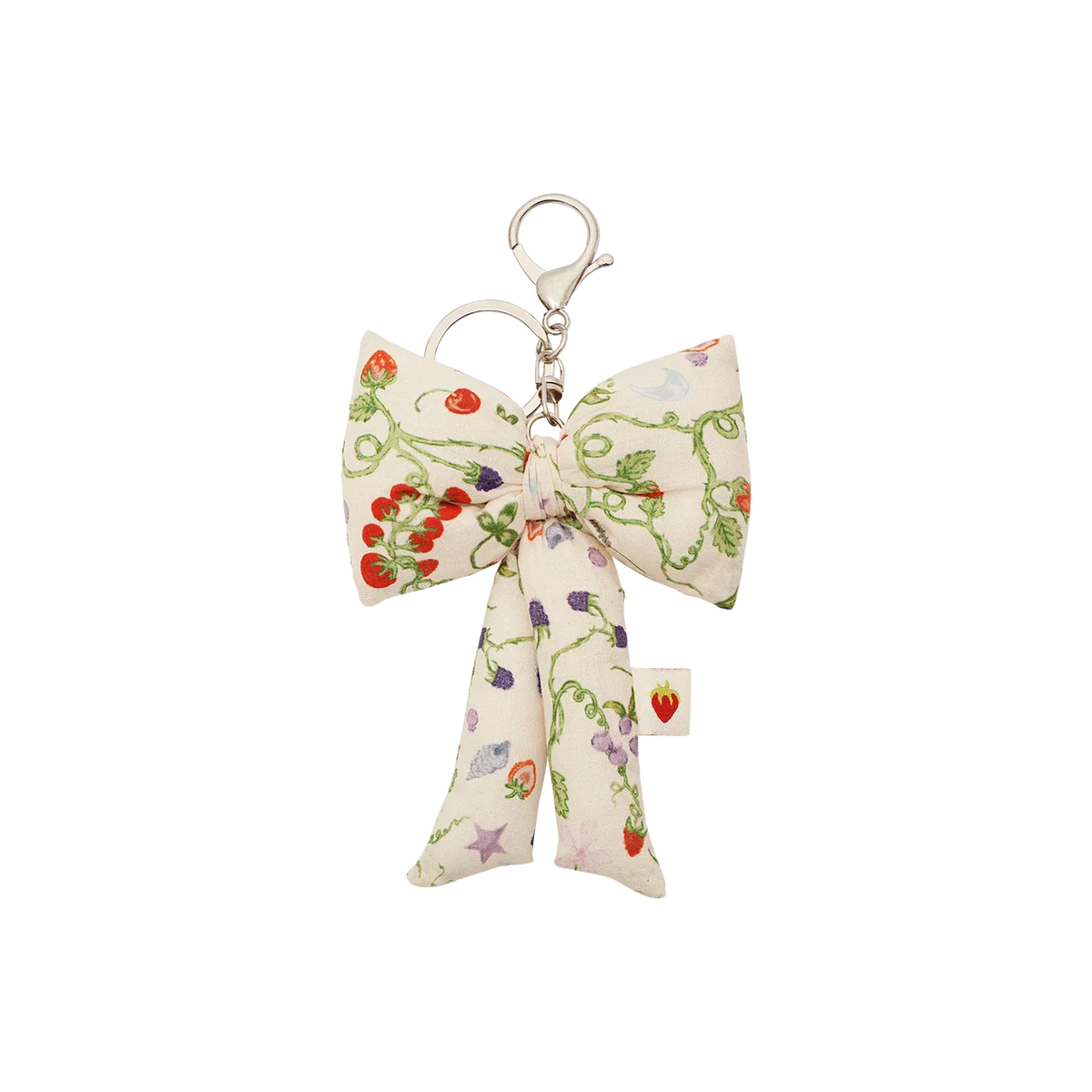 Maanesten Fabric Bow Key Ring Garden Magic Ivory har en stor rosett i tyg med blommönster och silverfärgad nyckelkrok. Modell 4111