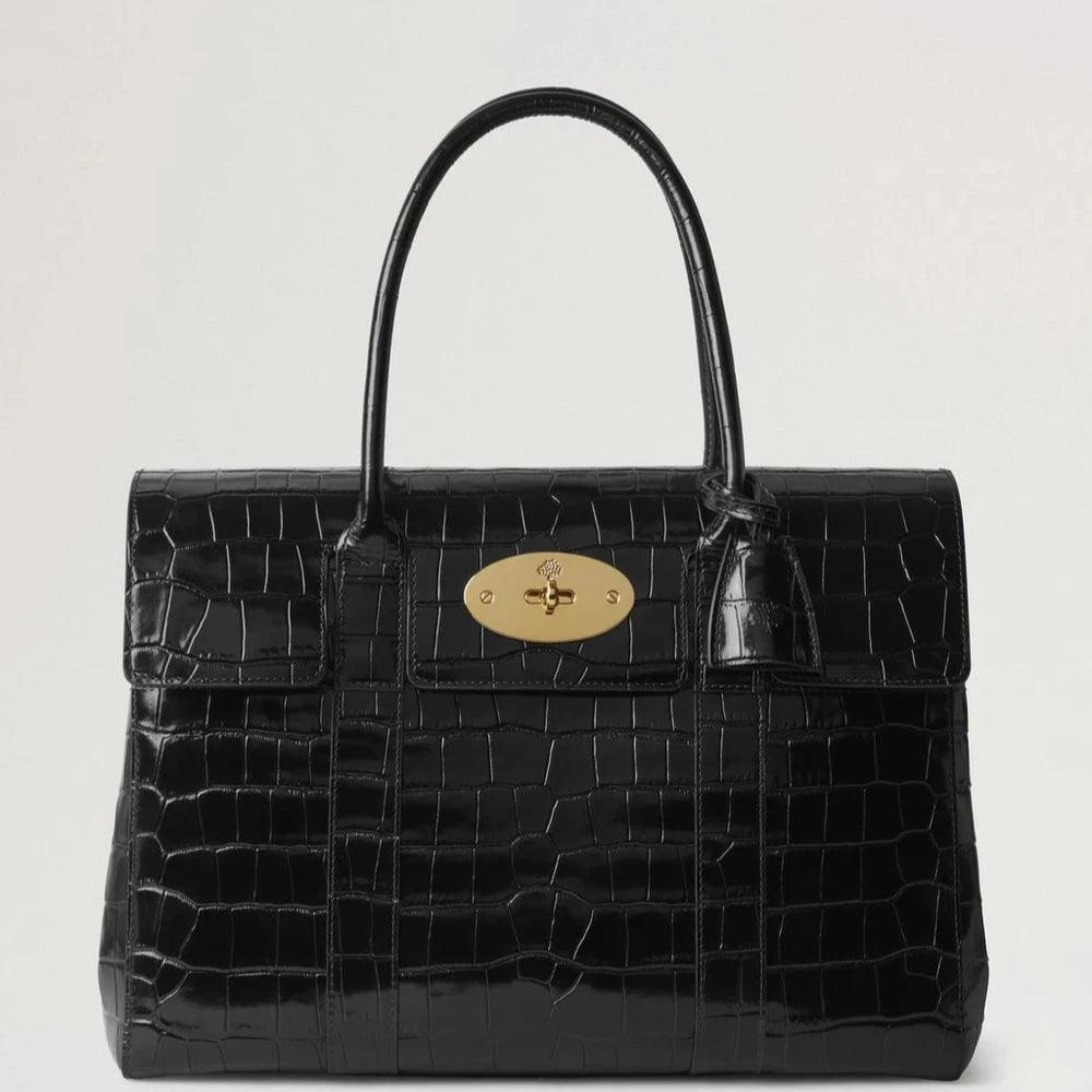 Mulberry Bayswater Croc Black visar en elegant svart handväska i krokodilpräglat läder med ett gyllene spänne. Modell HH9589641A100