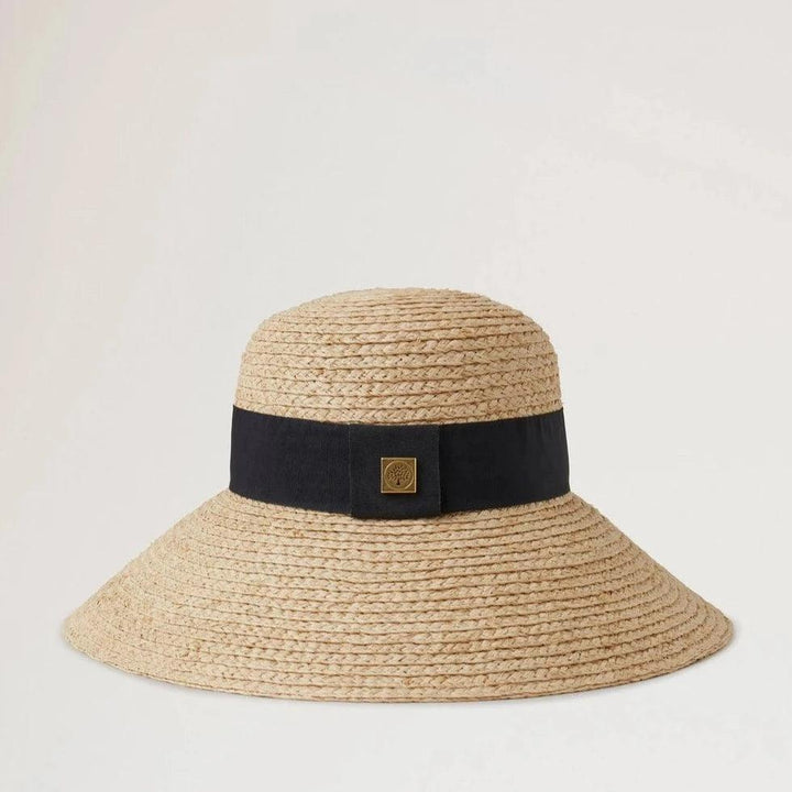 Mulberry Raffia Sun Hat Wide Brim shows a natural colored straw hat with a wide black band. Modell VH4136060H120-001-1