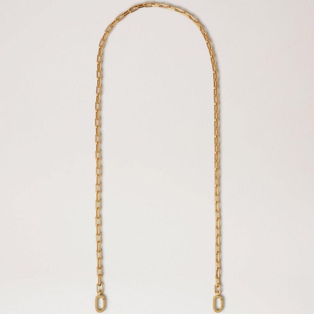 Mulberry Softie Chain Crossbody Strap i blank mässingsfärgad metall, elegant kedja mot ljus bakgrund. Modell RX0289000N188