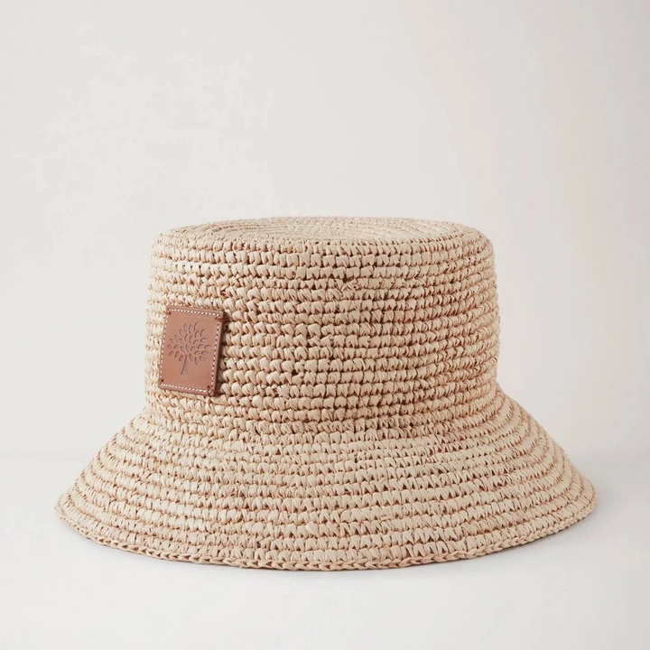 Mulberry Summer Raffia Bucket Hat visar en ljus flätad raffia sommarhatt med läderlapp. Modell VH4097807H120.