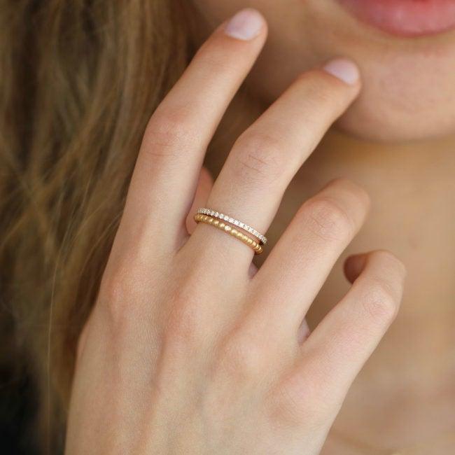 ro copenhagen 18kt orbit prick-ring bärs på kvinnans hand, elegant och i guld med diskreta detaljer, modell90878-001-2